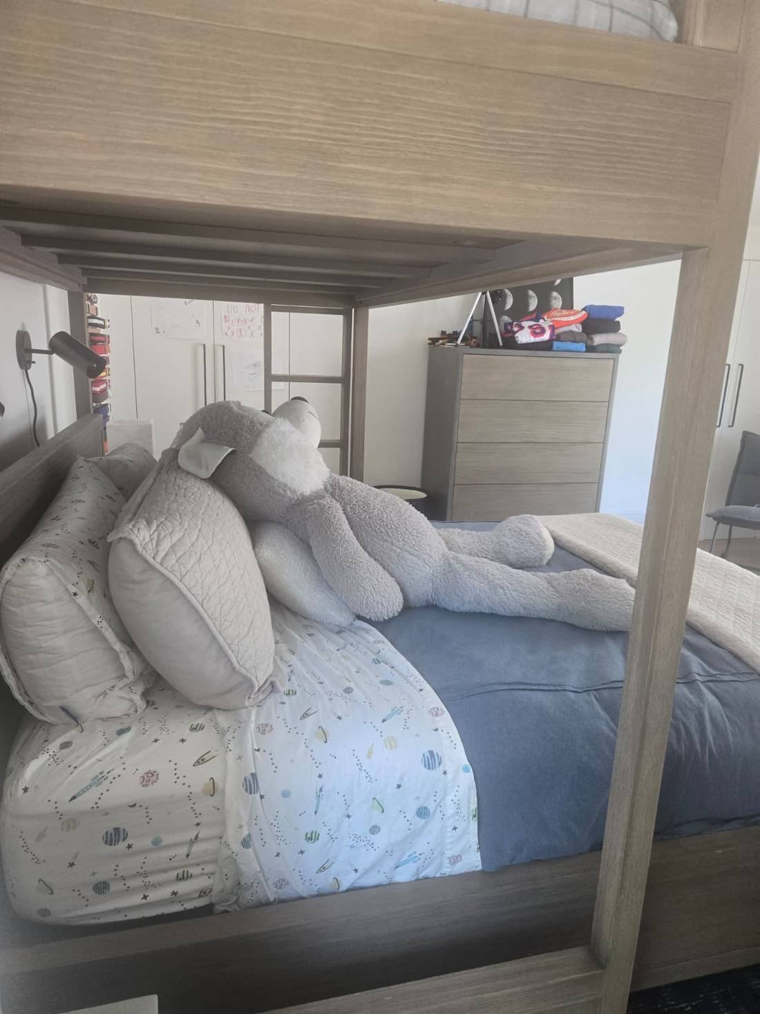 Organized bunk bed with neatly arranged pillows and stuffed animal after professional cleaning