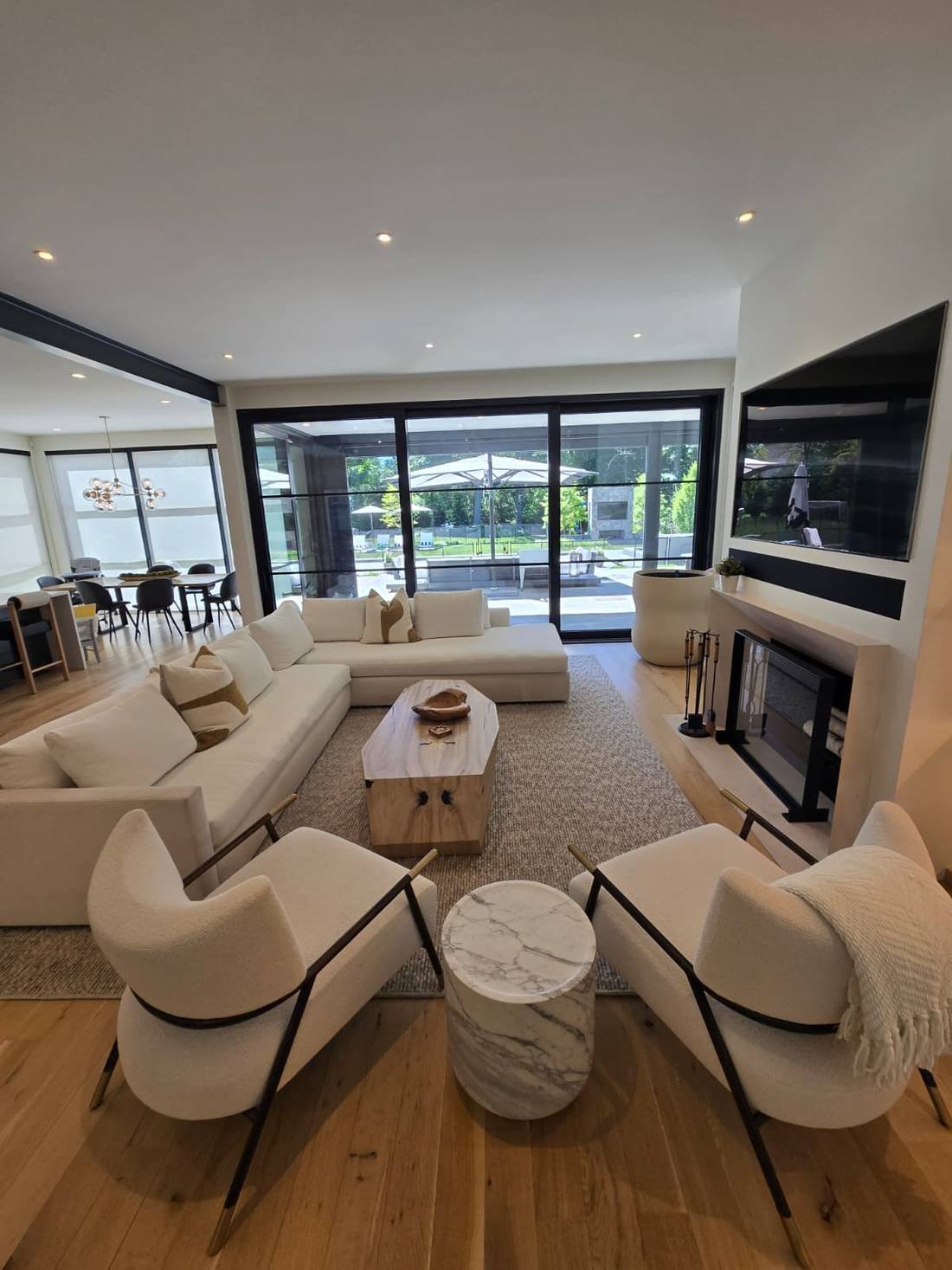 Clean organized living room with white sofas and tidy furniture after professional cleaning in Fairfield County CT
